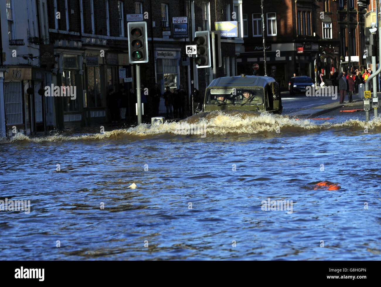 An Army Land Rover is driven through floodwater in York city centre after the River Ouse bursts its banks. Stock Photo