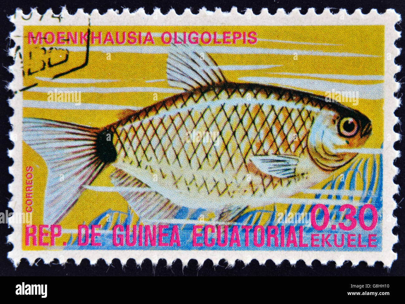 EQUATORIAL GUINEA - CIRCA 1974: A stamp printed in Guinea Ecuatorial dedicated to exotic fish shows moenkhausia oligolepis, circ Stock Photo