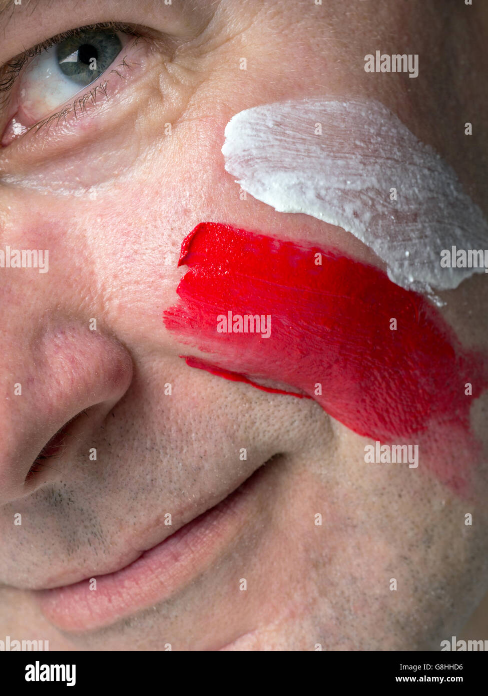 Closeup of young Polish supporter face painted with national flag colors Stock Photo