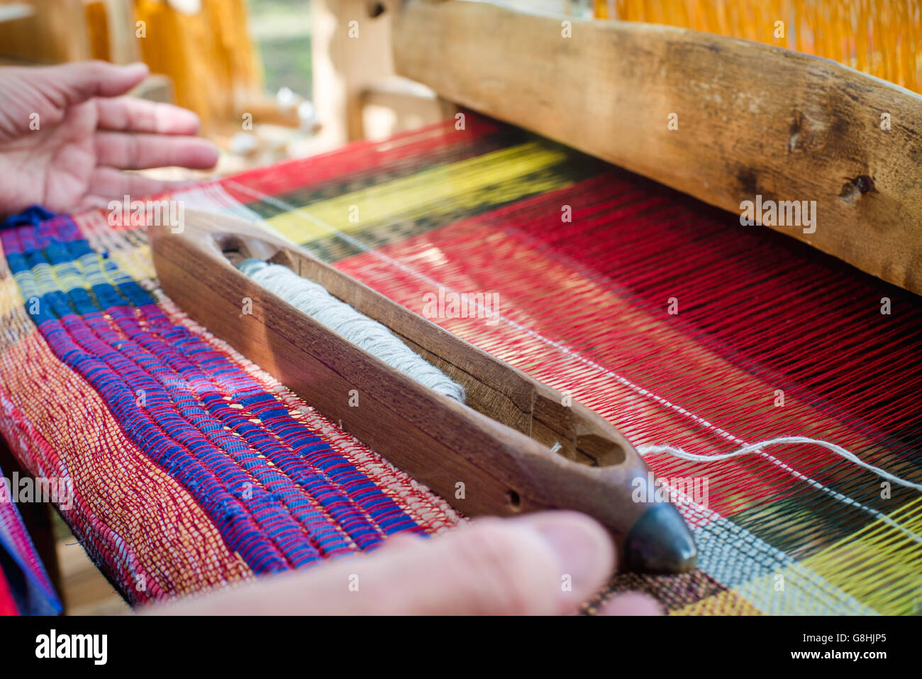 Weaving on a wooden loom Stock Photo - Alamy