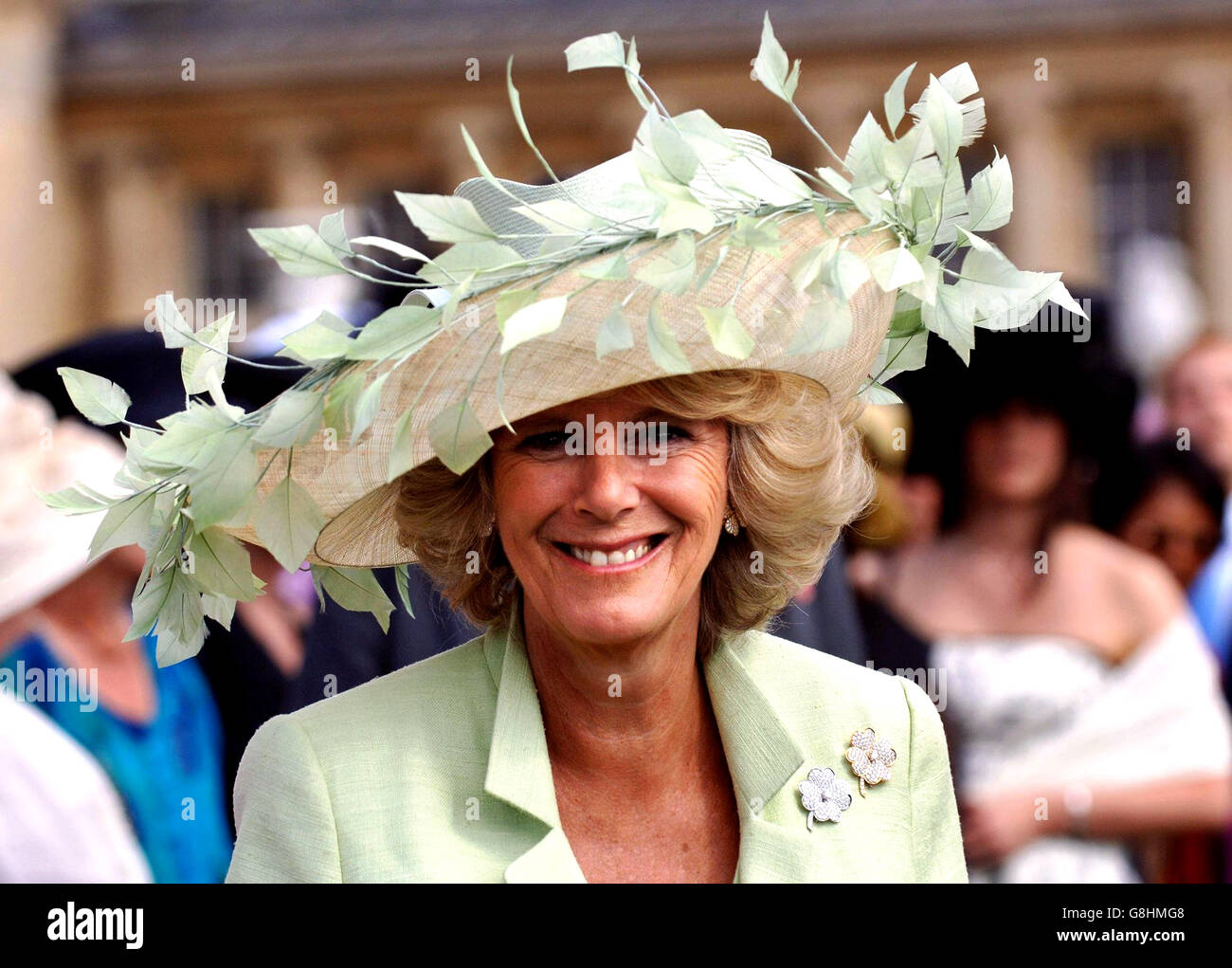 The Duchess of Cornwall attends her first garden party since her marriage to the Prince of Wales. Camilla is wearing a hat by Irish milliner Philip Treacy. Stock Photo