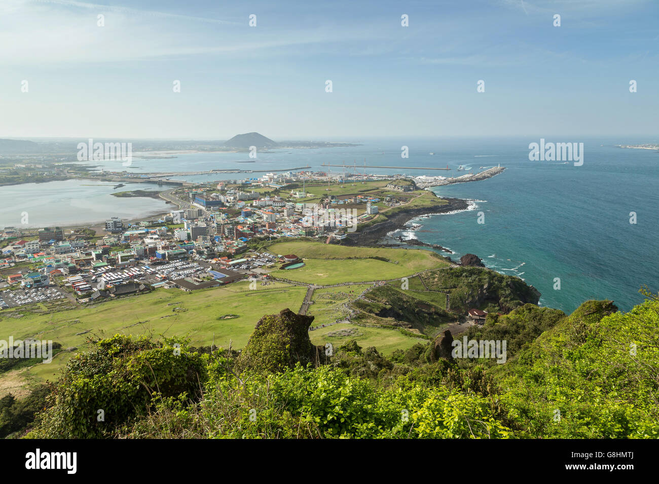 View of Seongsan-ri city and coastline from Seongsan Ilchulbong Peak on Jeju Island in South Korea. Stock Photo