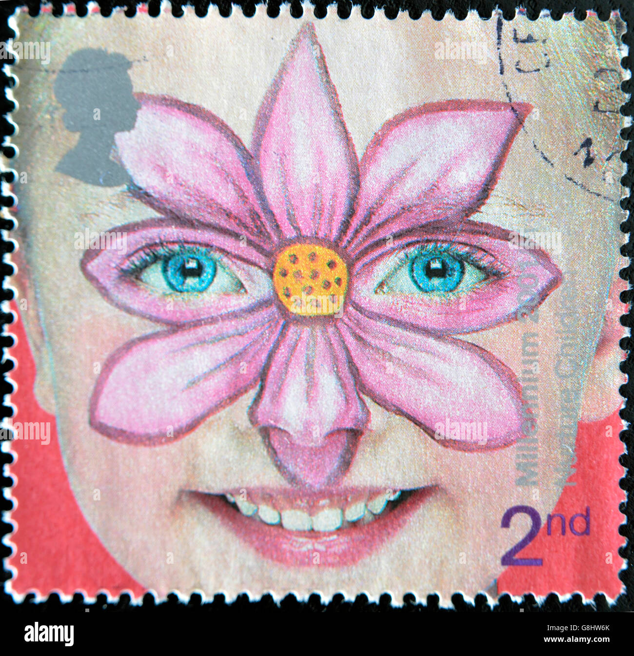 CIRCA 2001: A stamp printed in England, is dedicated to painted faces of children, flower, circa 2001 Stock Photo