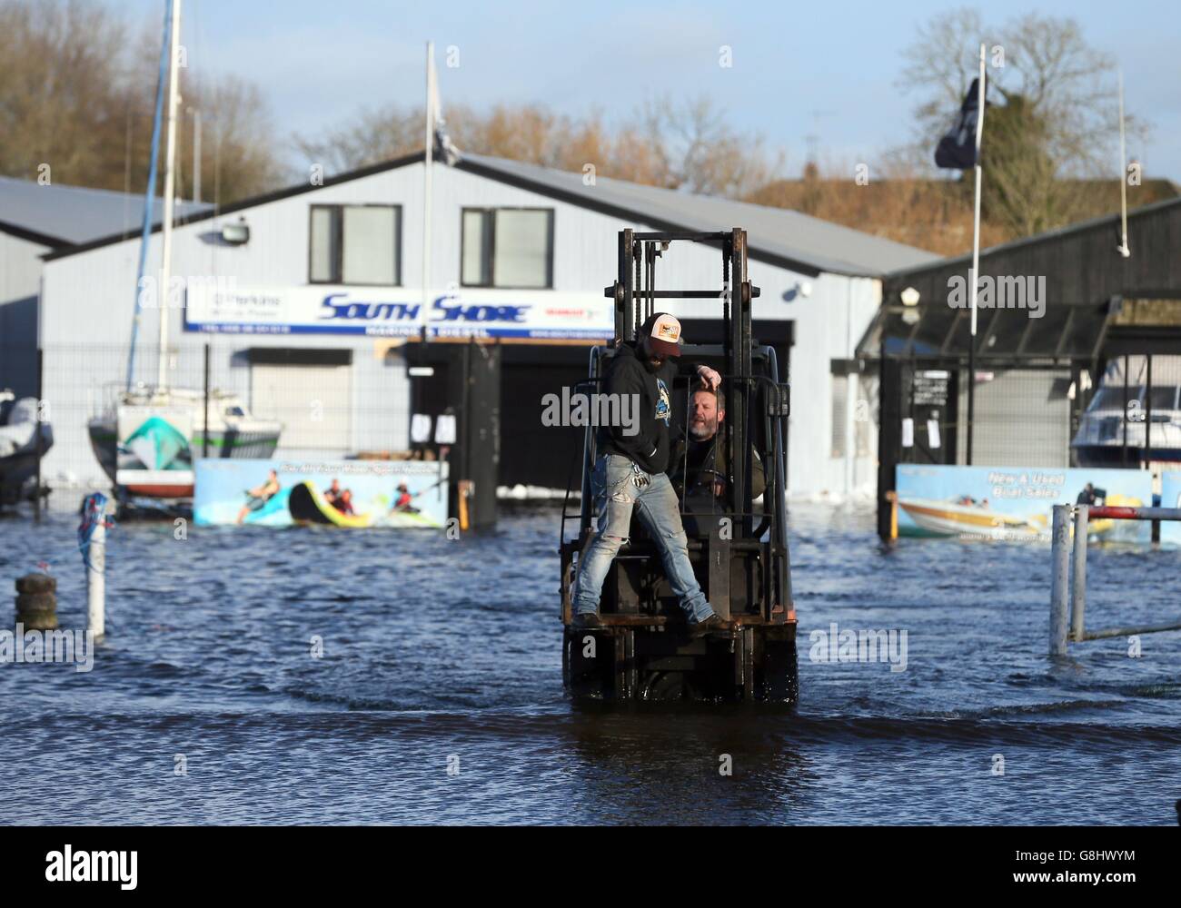 Business owners use a fork lift truck to cross flood waters at Kinnago Marina, near Dungannon, which is affected by the rising water levels in Lough Neagh. Stock Photo