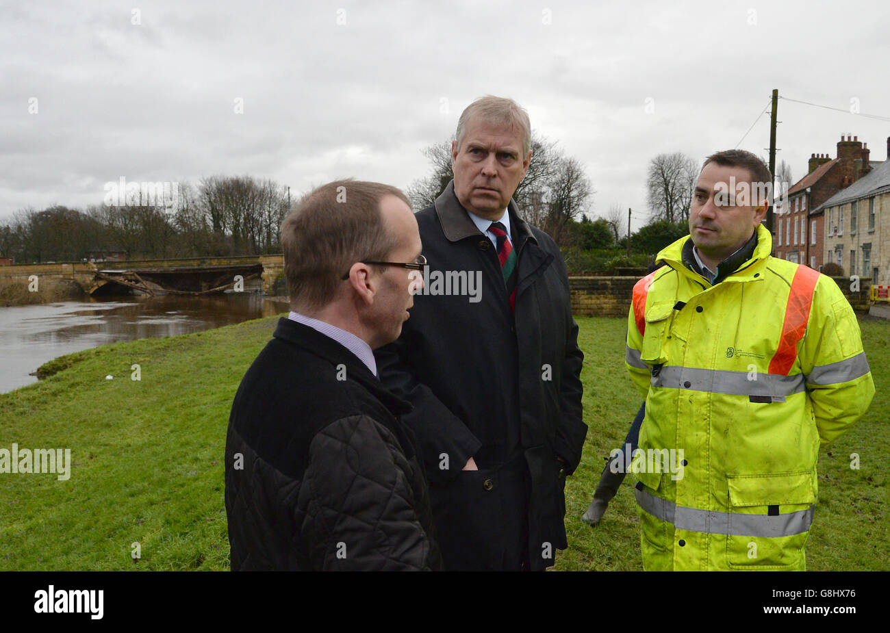 The Duke of York talks to Andrew Wood, Senior Engineer with North Yorkshire County Council (right), and Richard Sweeting, Chairman of Selby District Council, as they look at the damaged bridge over the River Wharfe in Tadcaster, during his visit to the area to view flood damage. Stock Photo