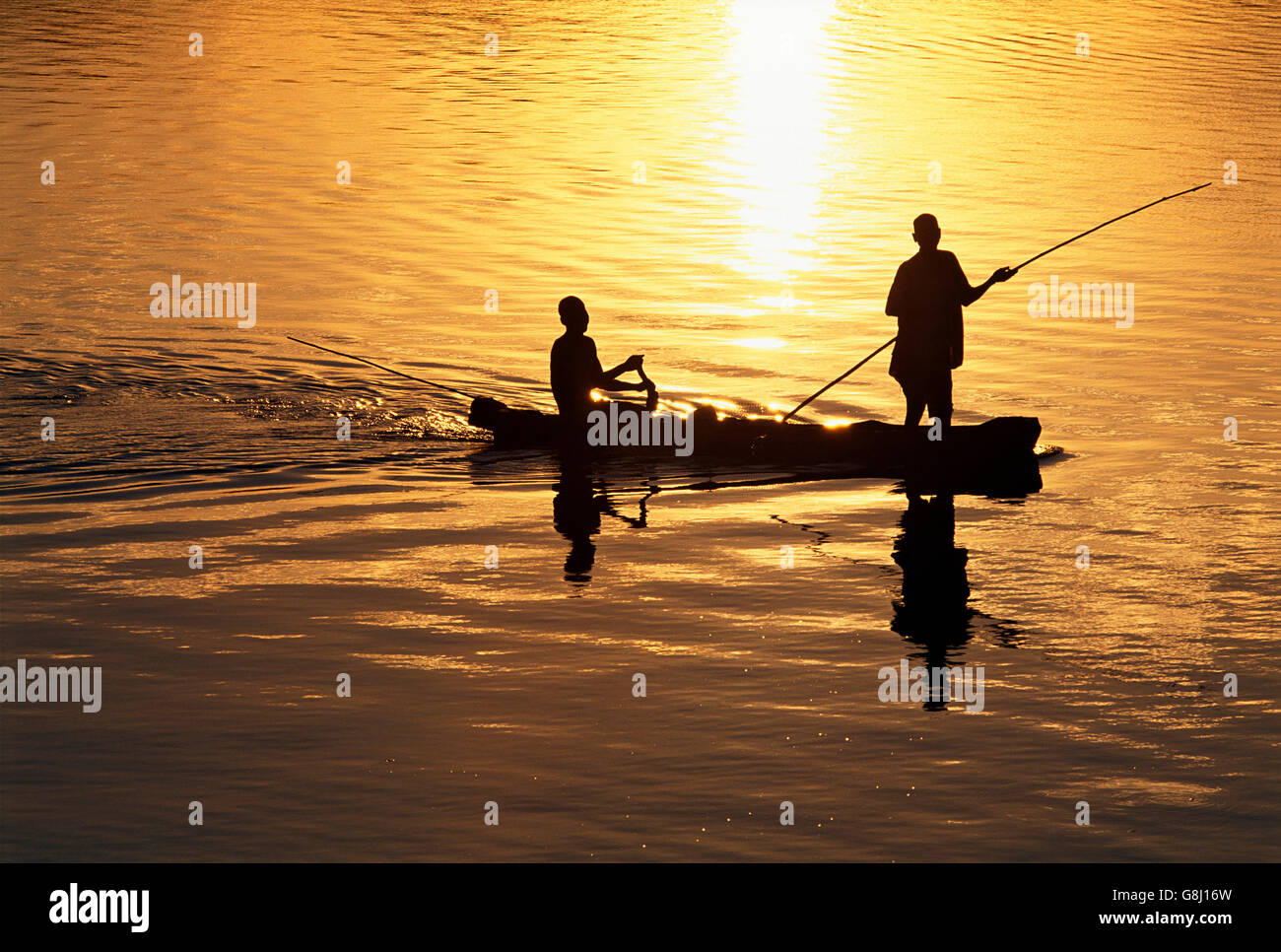 Fishermen on fishing boat during sunset, Silhouette, Luangwa River, Zambia. Stock Photo