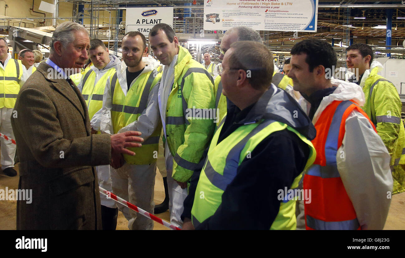 The Prince of Wales talks to workers during a visit to the McVitie's factory in Carlisle, which was damaged in the floods earlier in the month. Stock Photo