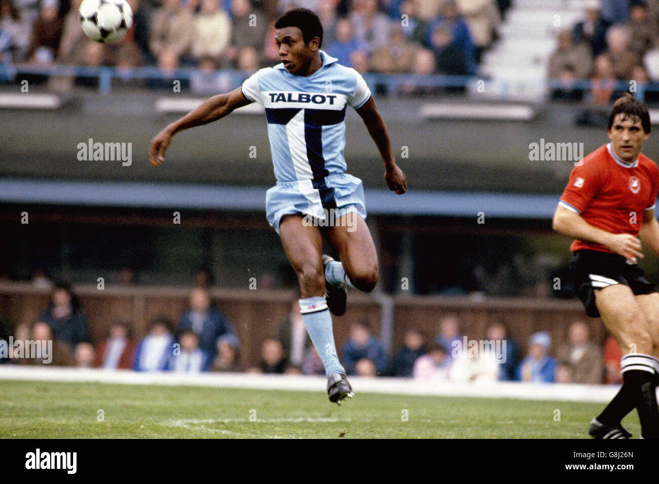 Coventry City's Danny Thomas (l) heads clear, watched by Swansea City's Bob Latchford (r) Stock Photo