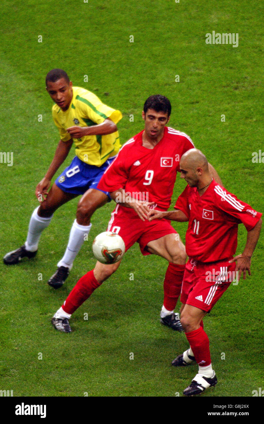 Soccer - FIFA World Cup 2002 - Semi Final - Brazil v Turkey. Turkey's Hasan Sas (r) and Hakan Sukur shield the ball from Brazil's Gilberto Silva Stock Photo