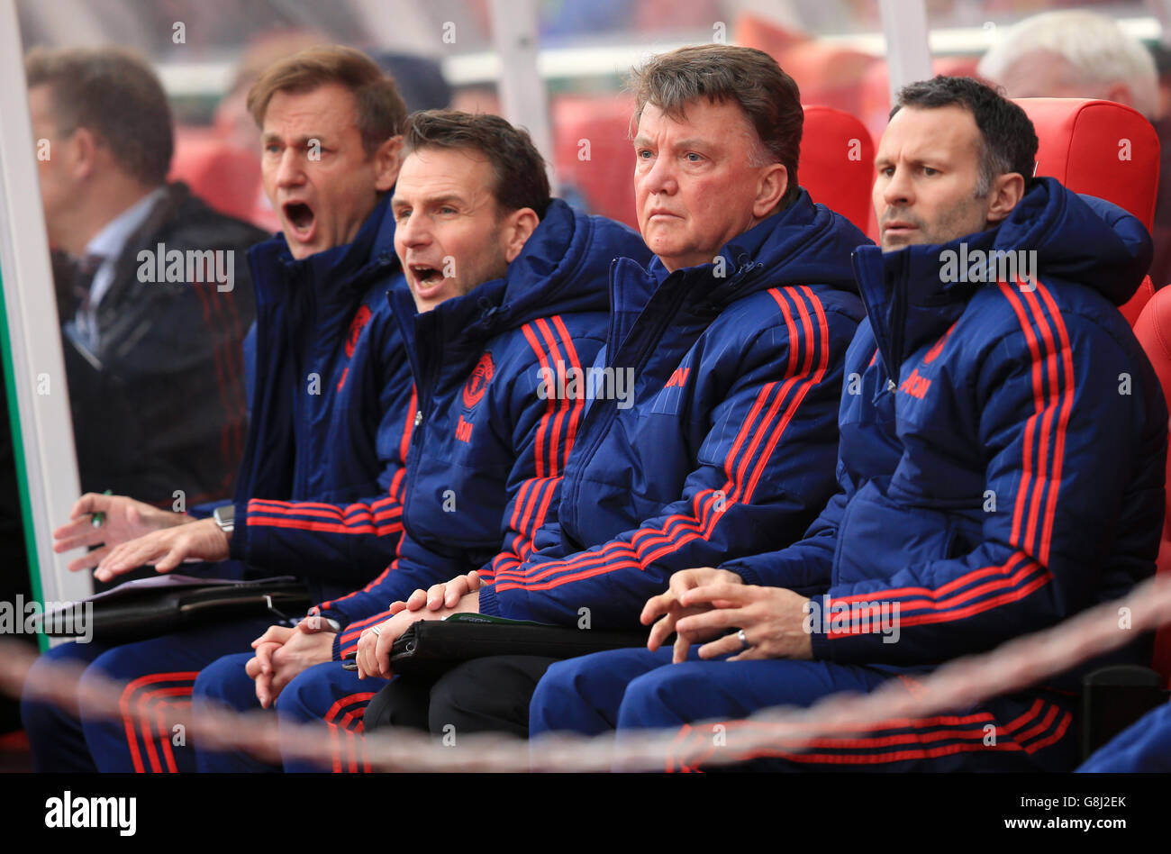Manchester United manager Louis van Gaal (second right) and his coaching  staff sit dejected on the bench during the Barclays Premier League match at  the Britannia Stadium, Stoke Stock Photo - Alamy