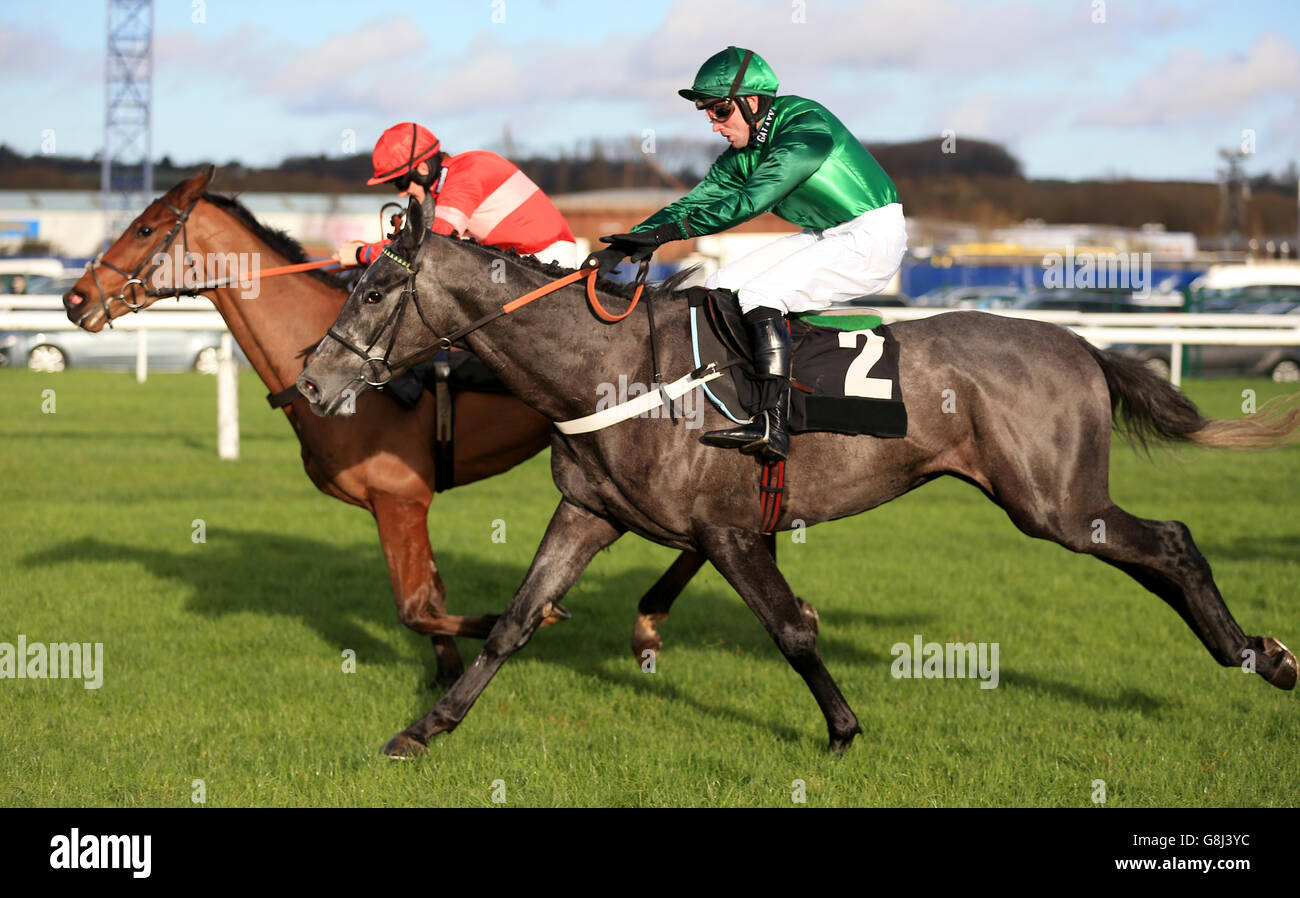 Fixe Le Kap (right) ridden by Jeremiah McGrath jumps the last fence to win the Betfred Mobile Juvenile Hurdle Race ahead of Tommy Silver ridden by Sam Twiston-Davies during the Betfred Challow Hurdle Day at Newbury Raceocurse, Newbury. Stock Photo