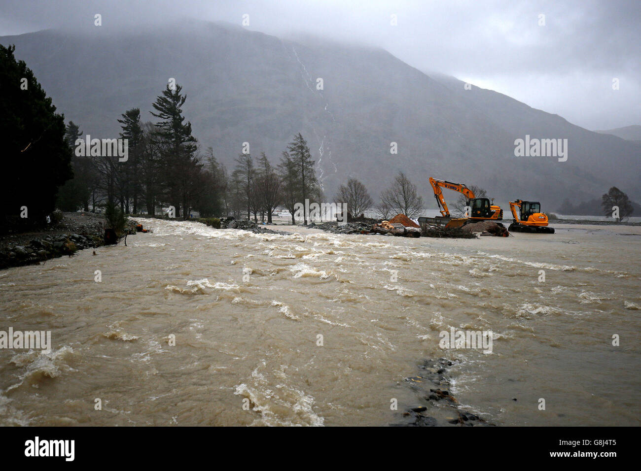 A view of a flooded road at Ullswater in Glenridding, Cumbria, as Storm Frank begins to batter the UK on its way towards flood-hit areas. Stock Photo
