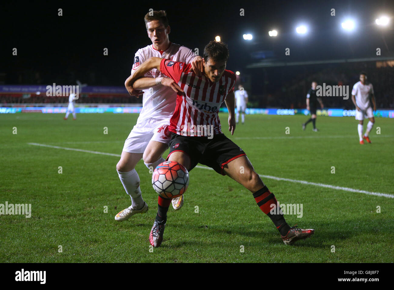 Liverpool's Ryan Kent (left) and Exeter City's Craig Woodman (right) battle for the ball during the Emirates FA Cup, third round match at St James Park, Exeter. Stock Photo
