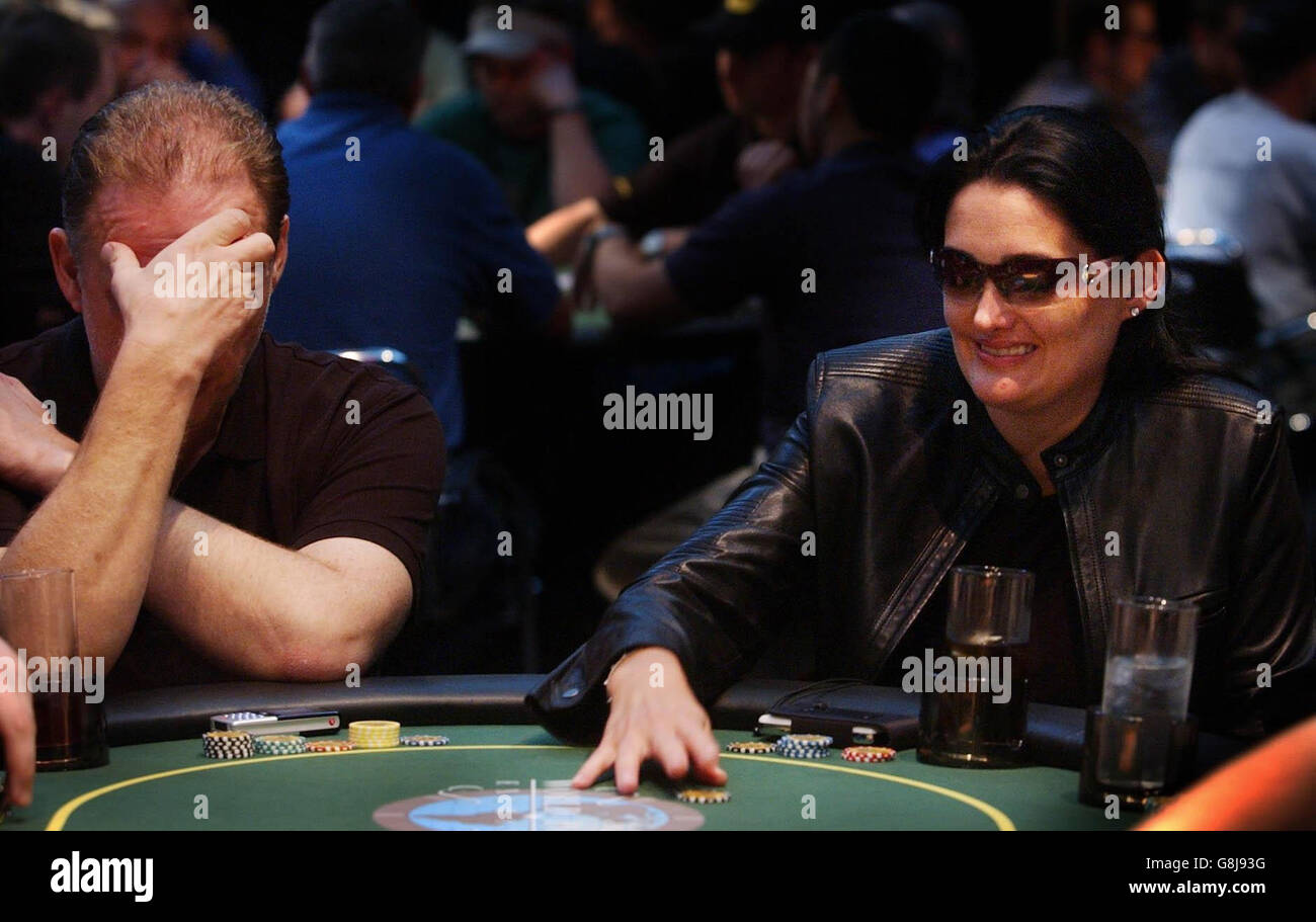 Kristy Gazes, the recent $2million winner of the 'Full Tilt' tournament in Las Vegas, claims the chips, to the ire of Trevor Carr (left). Stock Photo