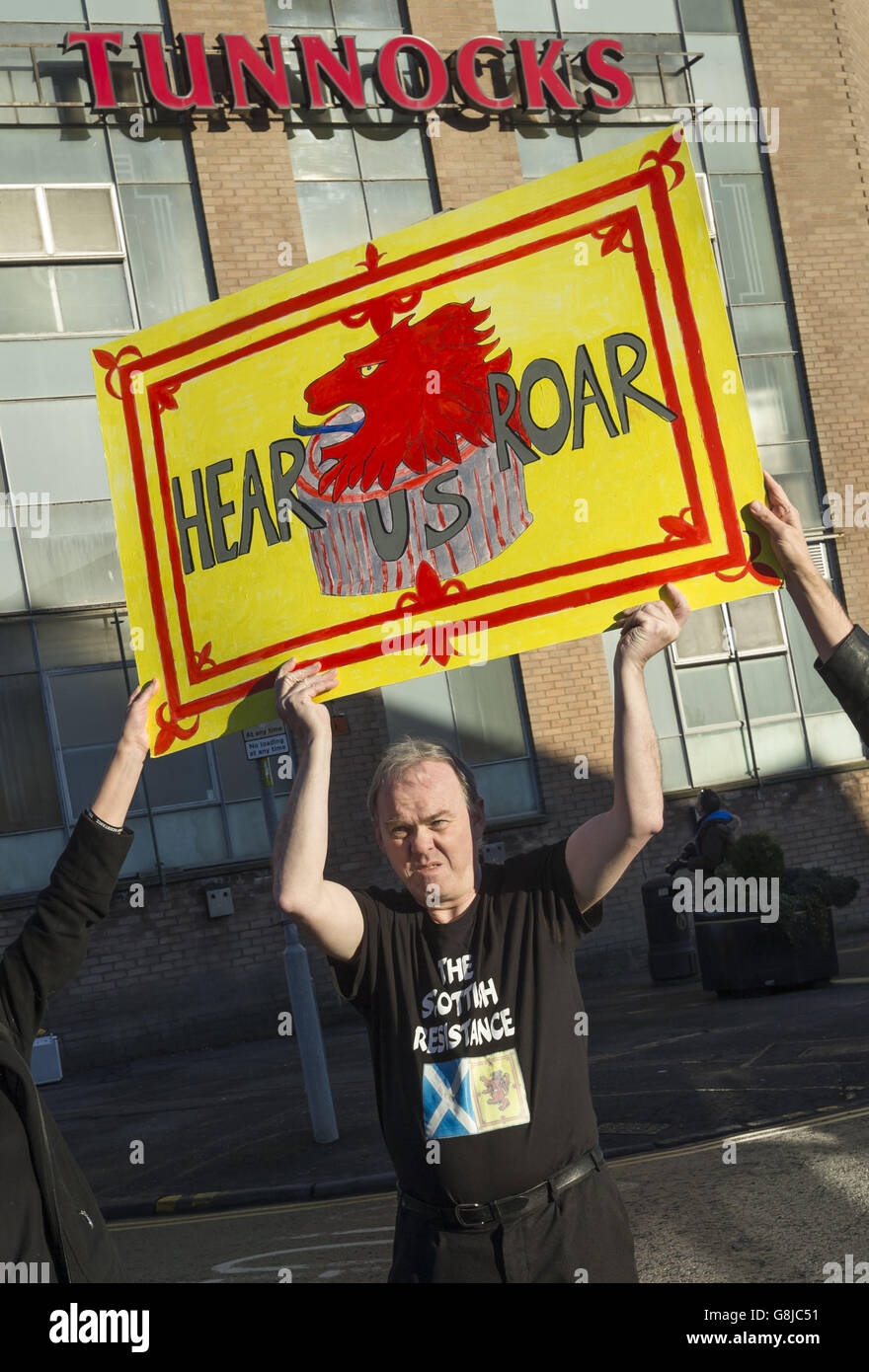 Activist Sean Clerkin from the Scottish Resistance group takes part in a protest outside Tunnock's factory in Uddingston, Lanarkshire, a week after the firm advertised its best-selling biscuit as the Great British Tea Cake. Stock Photo