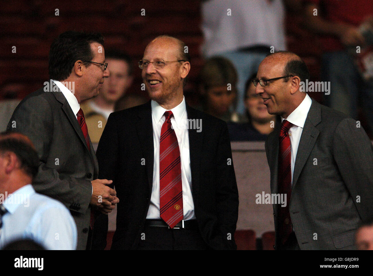 l-r Bryan, Avram and Joel Glazer in the crowd to watch the Manchester United and Debrecan game Stock Photo