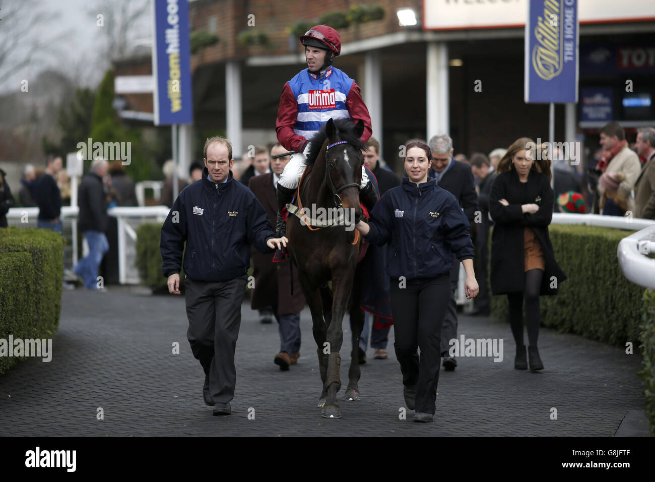 Jockey Wayne Hutchinson is lead to the winner's enclosure on Gibralfaro