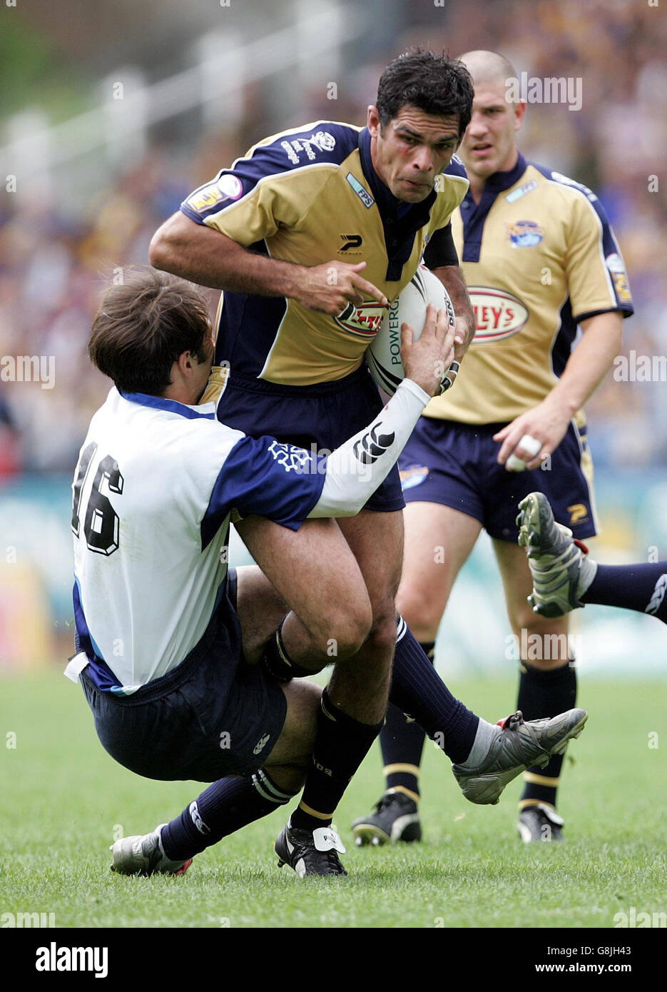 Leeds Rhinos' Chris McKenna (R) bursts through the tackle of ...