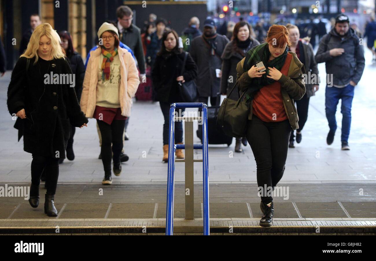 Commuters outside King's Cross railway station, London, as a study revealed that workers who commute by train spend up to six times as much of their salaries on fares as European passengers on publicly owned railways. Stock Photo