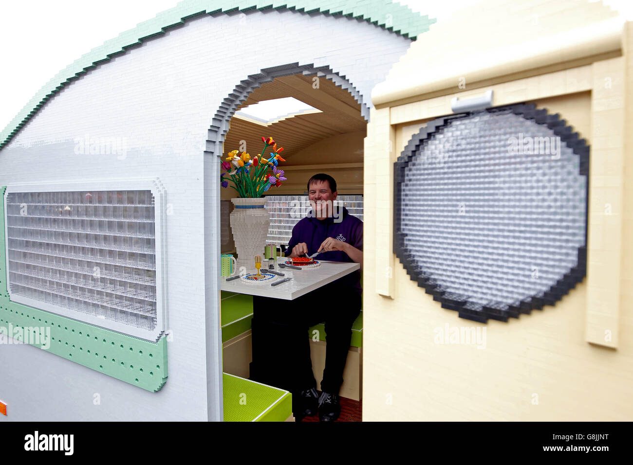 Ed Diment, Director at Bright Bricks with a full size caravan which has been made out of LEGO bricks by the company in Bordon, Hampshire. Stock Photo