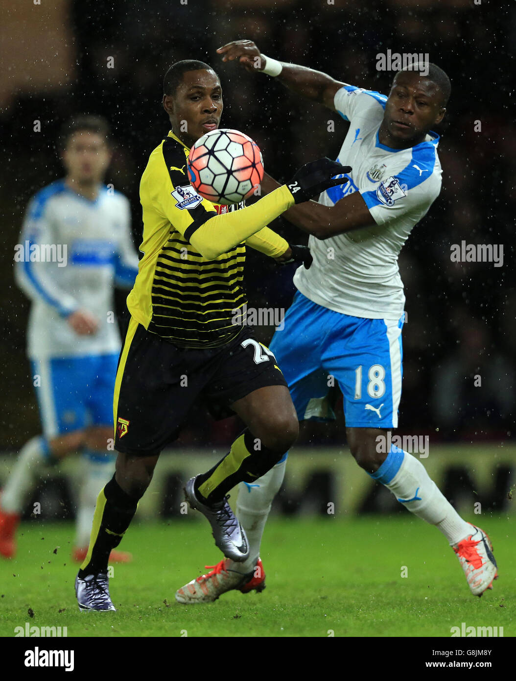 Watford's Odion Ighalo (left) and Newcastle United's Chancel Mbemba battle for the ball during the Emirates FA Cup, third round game at Vicarage Road, Watford. Stock Photo