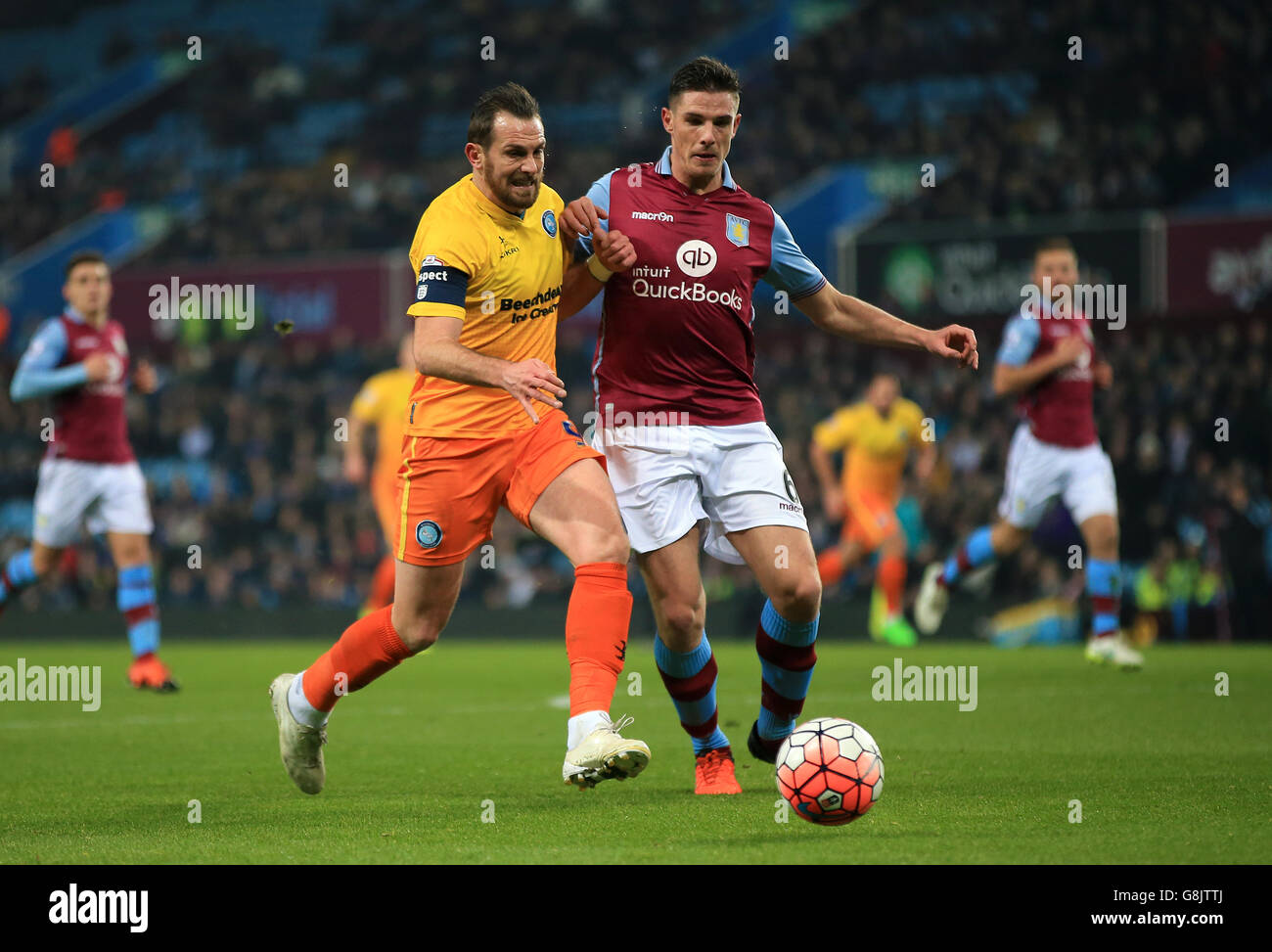 Wycombe Wanderers' Paul Hayes (left) and Aston Villa's Ciaran Clark battle for the ball during the Emirates FA Cup, third round replay at Villa Park, Birmingham. Stock Photo