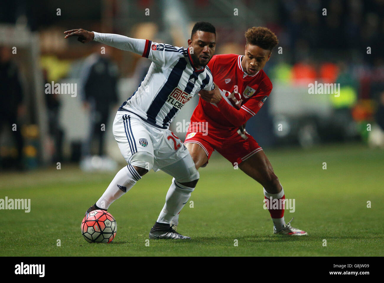 West Bromwich Albion's Stephane Sessegnon (left) is challenged by Bristol City's Bobby Reid during the Emirates FA Cup, third round replay at Ashton Gate, Bristol. Stock Photo