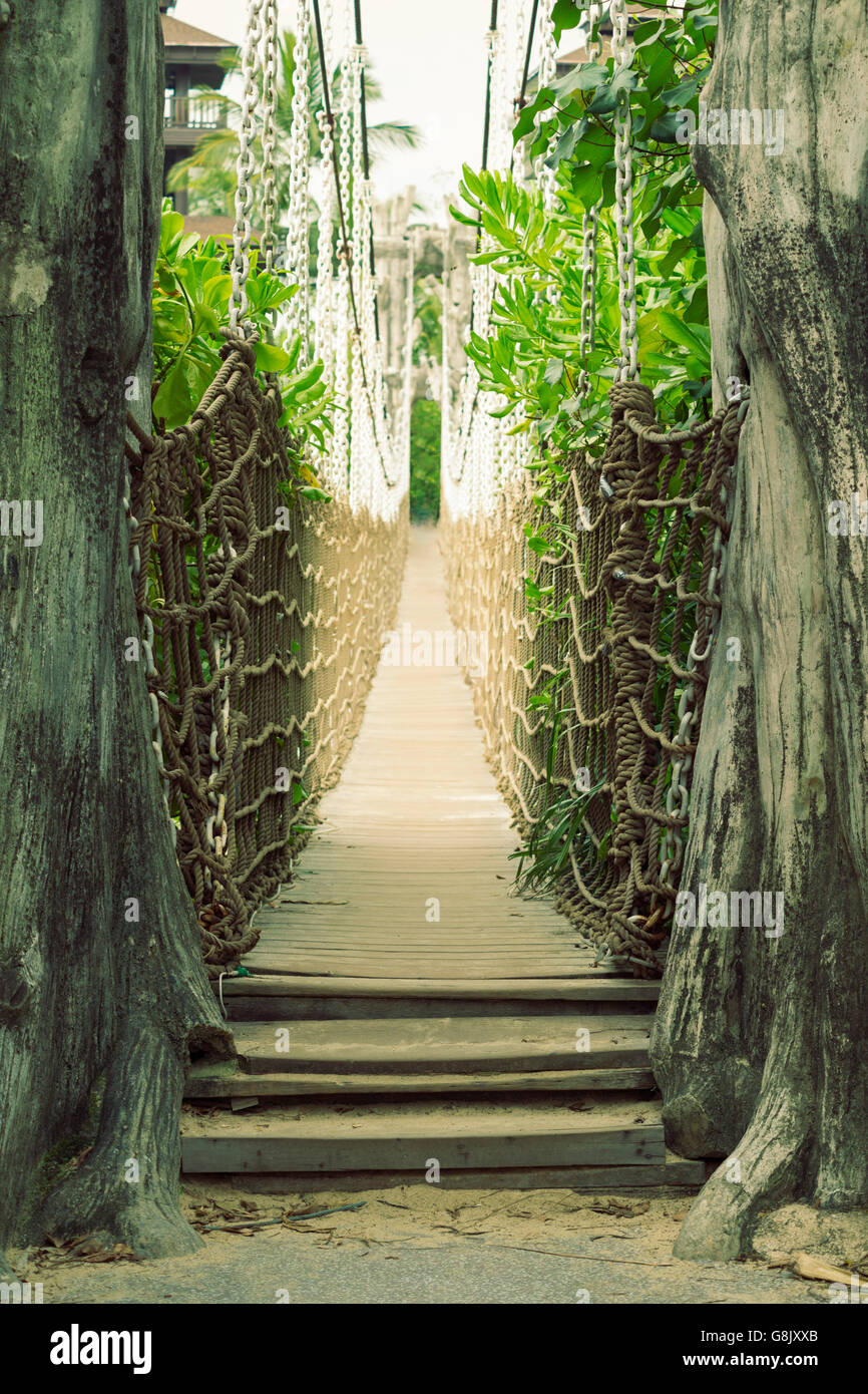 empty scenic wooden pathway through the rope bridge on Sentosa Island in Singapore Stock Photo