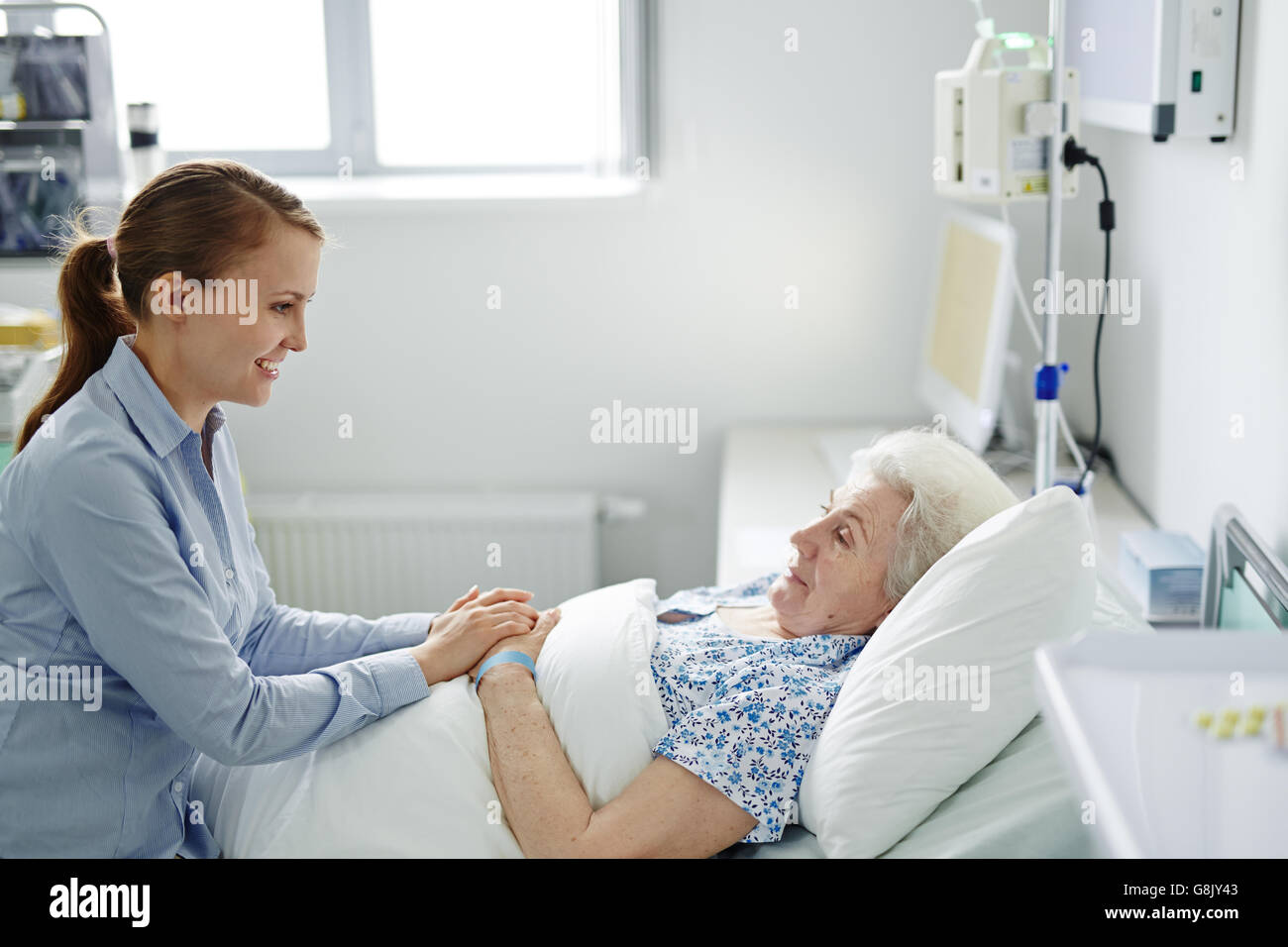 Visiting grandmother in hospital Stock Photo