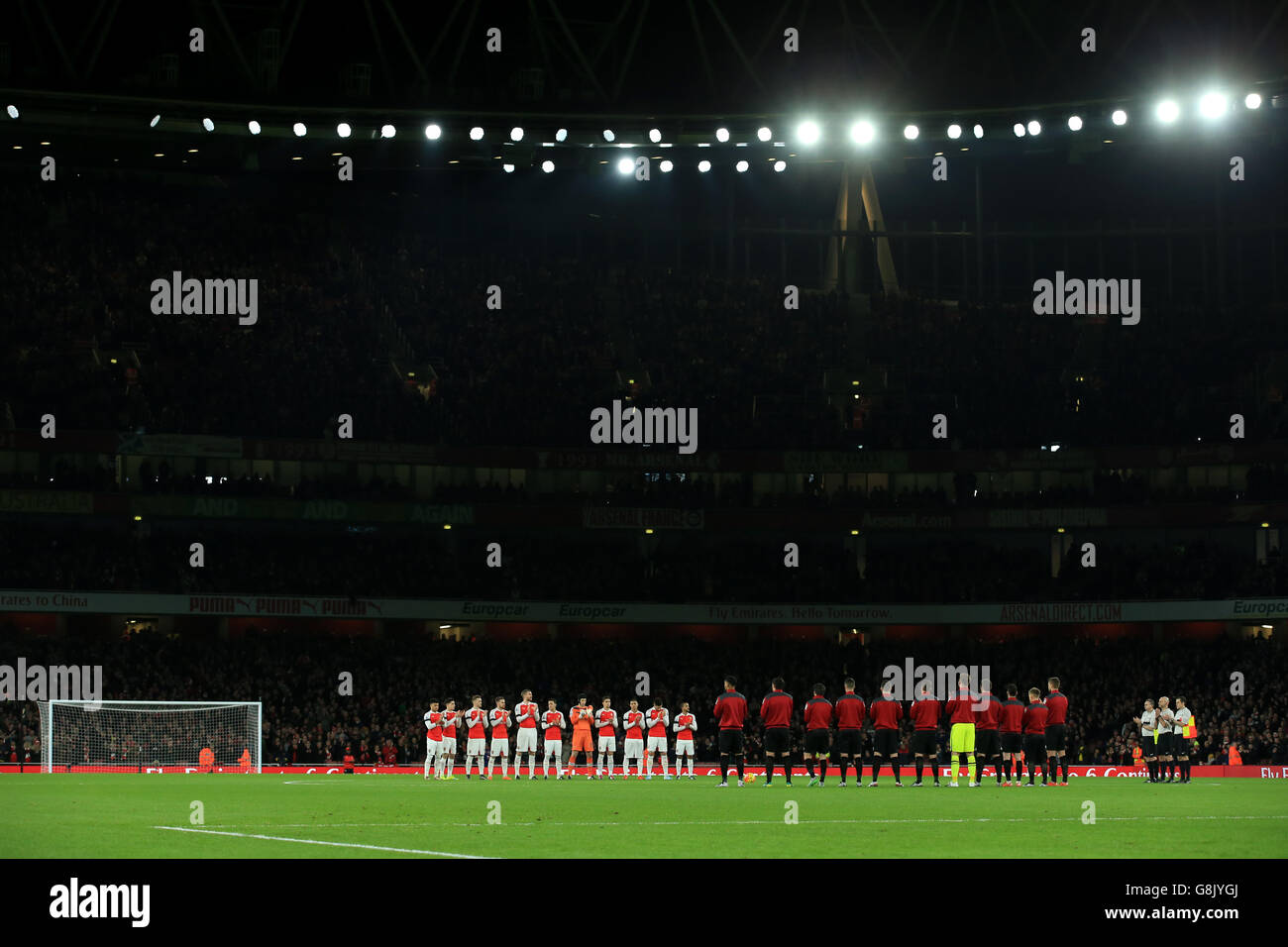 Arsenal's player's during a minute's applause for their former player
