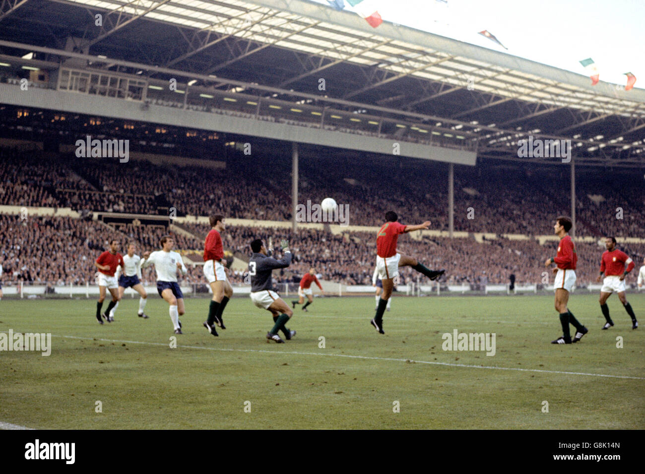 Portugal's Alberto Festa (third r) heads clear as goalkeeper Jose Pereira (fourth r) comes for the ball, watched by teammates Mario Coluna (r), Alexandre Baptista (second r), Hilario (l) and Jose Carlos (fourth l), and England's Jack Charlton (second l) and Geoff Hurst (third l) Stock Photo