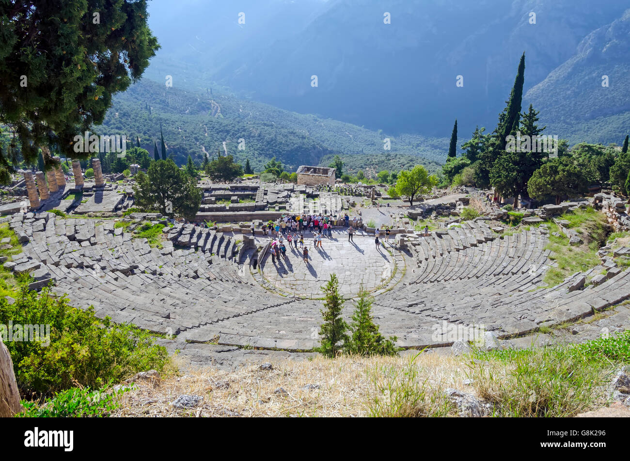 Above Delphi Theatre looking down on valley and group of tourists, Archaeological Site of Delphi Greece Stock Photo
