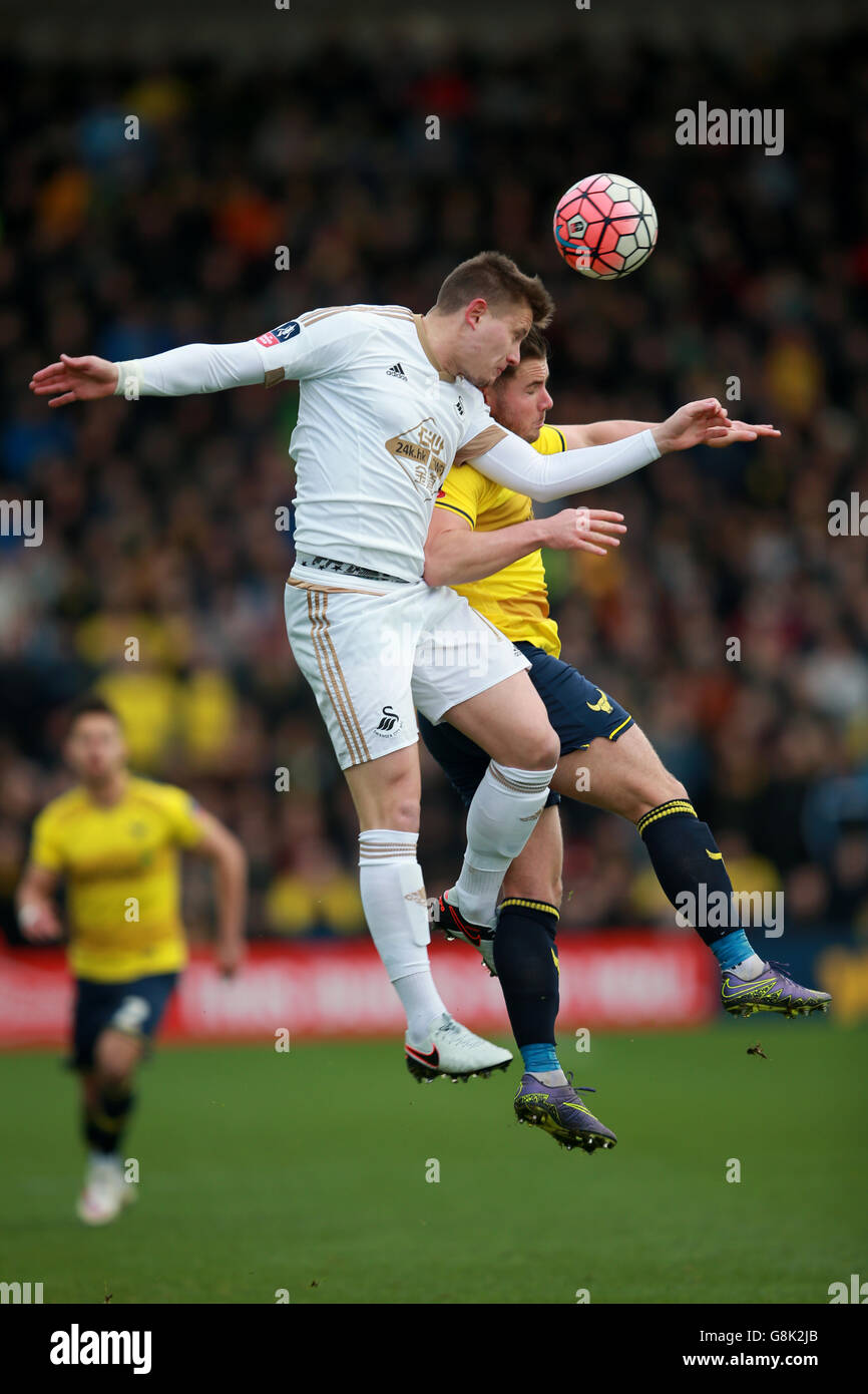Swansea City's Franck Tabanou and Oxford United's Alexander MacDonald battle for the ball during the Emirates FA Cup, third round match at the Kassam Stadium, Oxford. Stock Photo