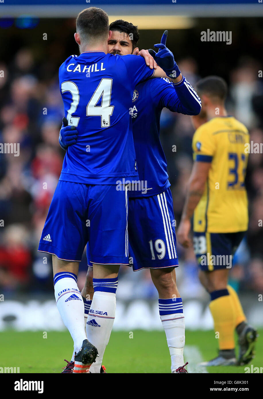 Chelsea's Diego Costa (centre) celebrates scoring their first goal of the game with team-mate Gary Cahill during the Emirates FA Cup, third round match at Stamford Bridge, London. Stock Photo
