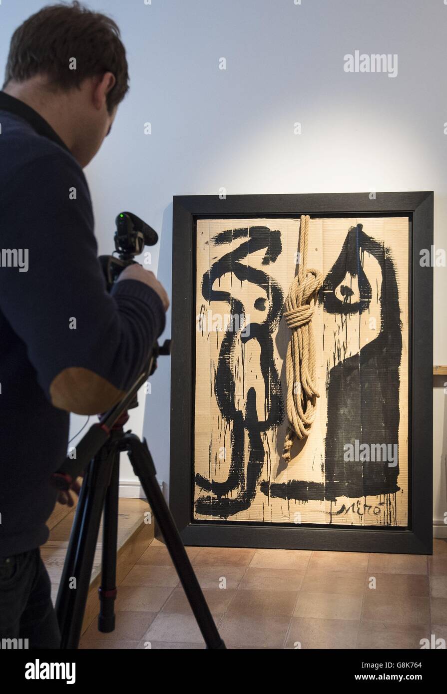 A member of the media records a painting by Miro at the Mayoral art gallery in London, where a recreation of Spanish painter Joan Miro's studio which was founded 60 years ago in Majorca is exhibited. Stock Photo