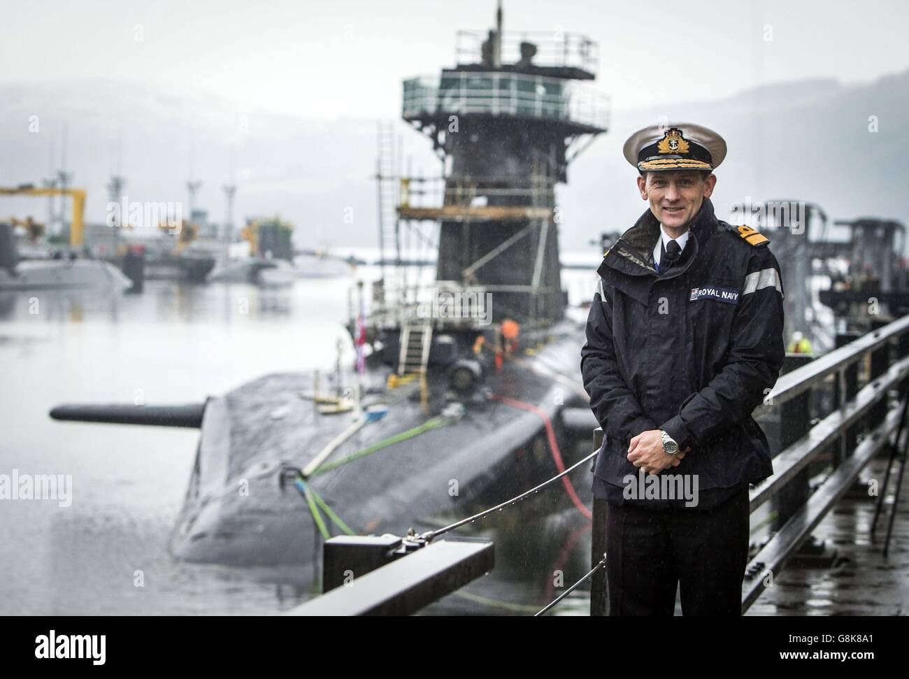 Rear Admiral of Submarines and Assistant Chief of Naval Staff John Weale with Vanguard-class submarine HMS Vigilant, one of the UK's four nuclear warhead-carrying submarines, at HM Naval Base Clyde, also known as Faslane, ahead of a visit by Defence Secretary Michael Fallon. Stock Photo