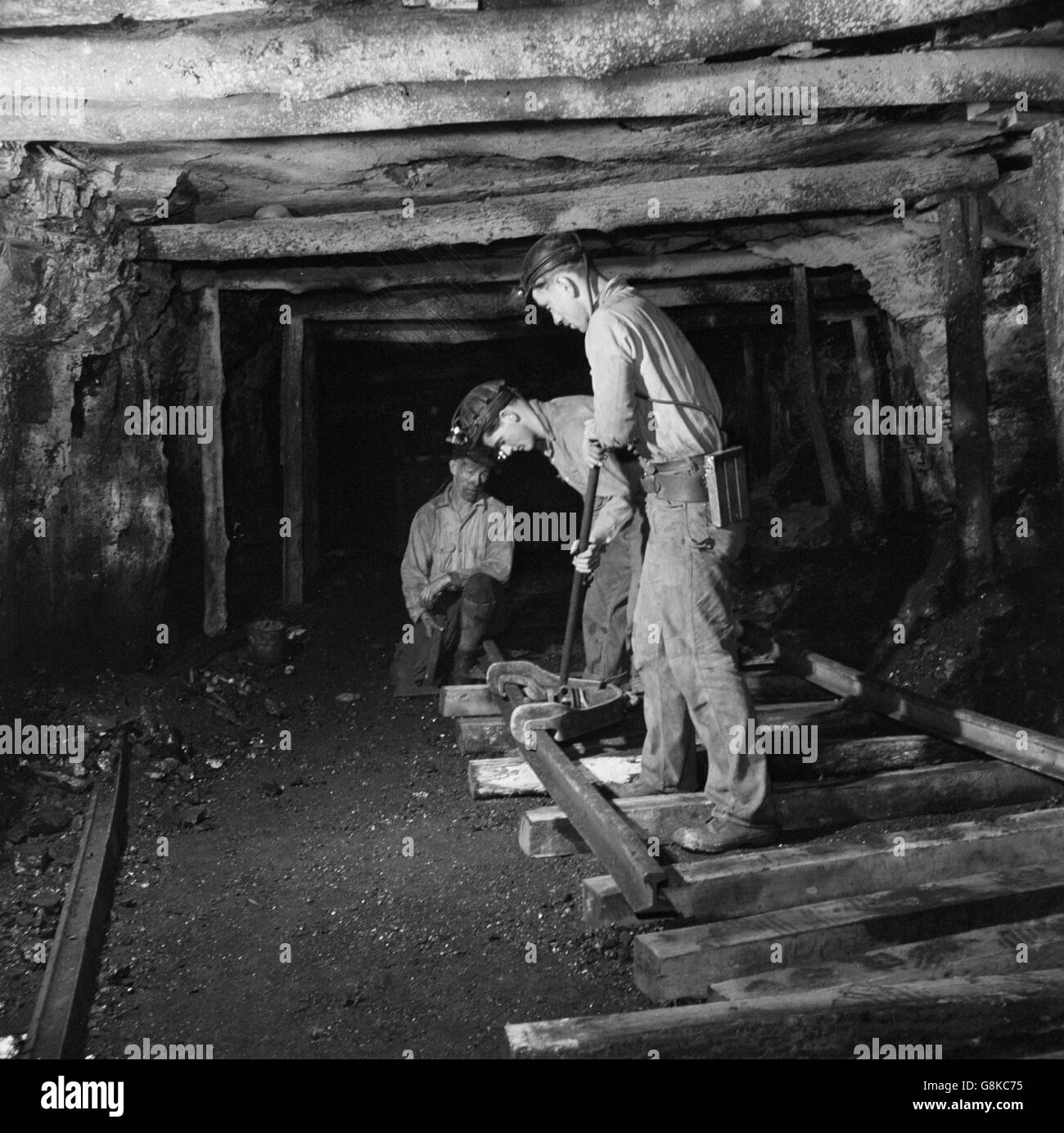 Three Miners Laying Track in Montour No. 4 Mine of Pittsburgh Coal Company, Pittsburgh, Pennsylvania, USA, John Collier for Office of War Information, November 1942 Stock Photo