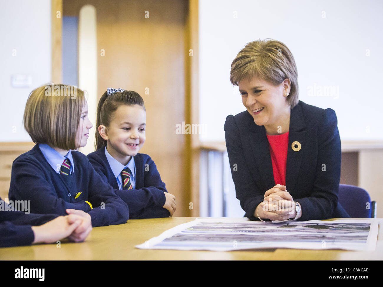First Minister Nicola Sturgeon joins St Mary's Primary School pupils Olivia Auld (left) and Abbie Flynn during a visit to Discovery Point in Dundee, Scotland, to see the progress of the the £1 billion Waterfront regeneration project. Stock Photo