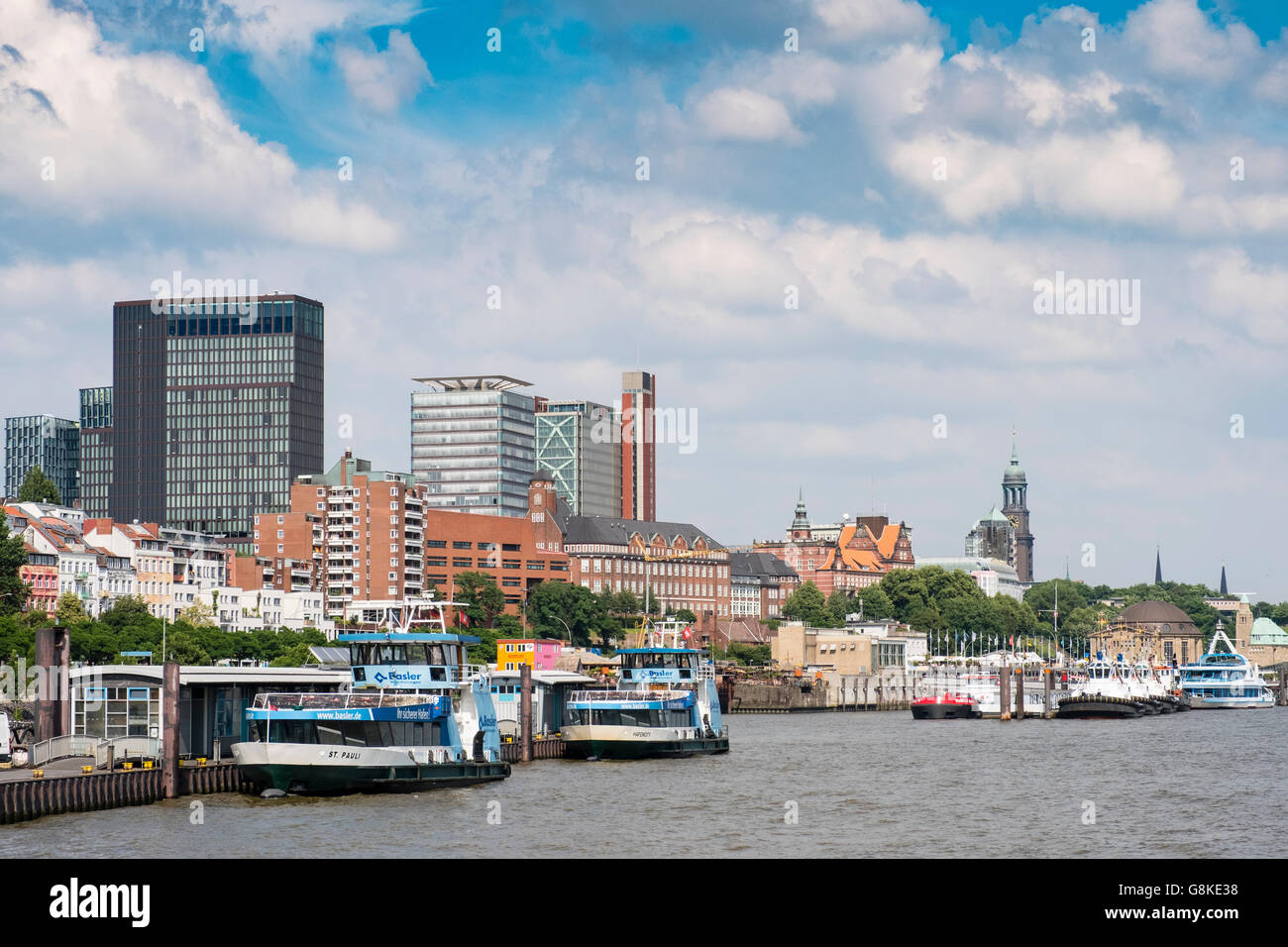 Skyline of Hamburg and ferry landing bridges from the River Elbe in Germany Stock Photo