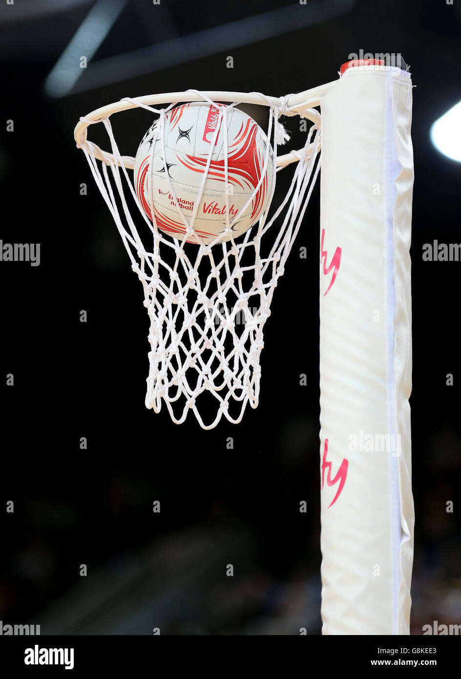 A detail view of a Gilbert netball dropping into a net Stock Photo
