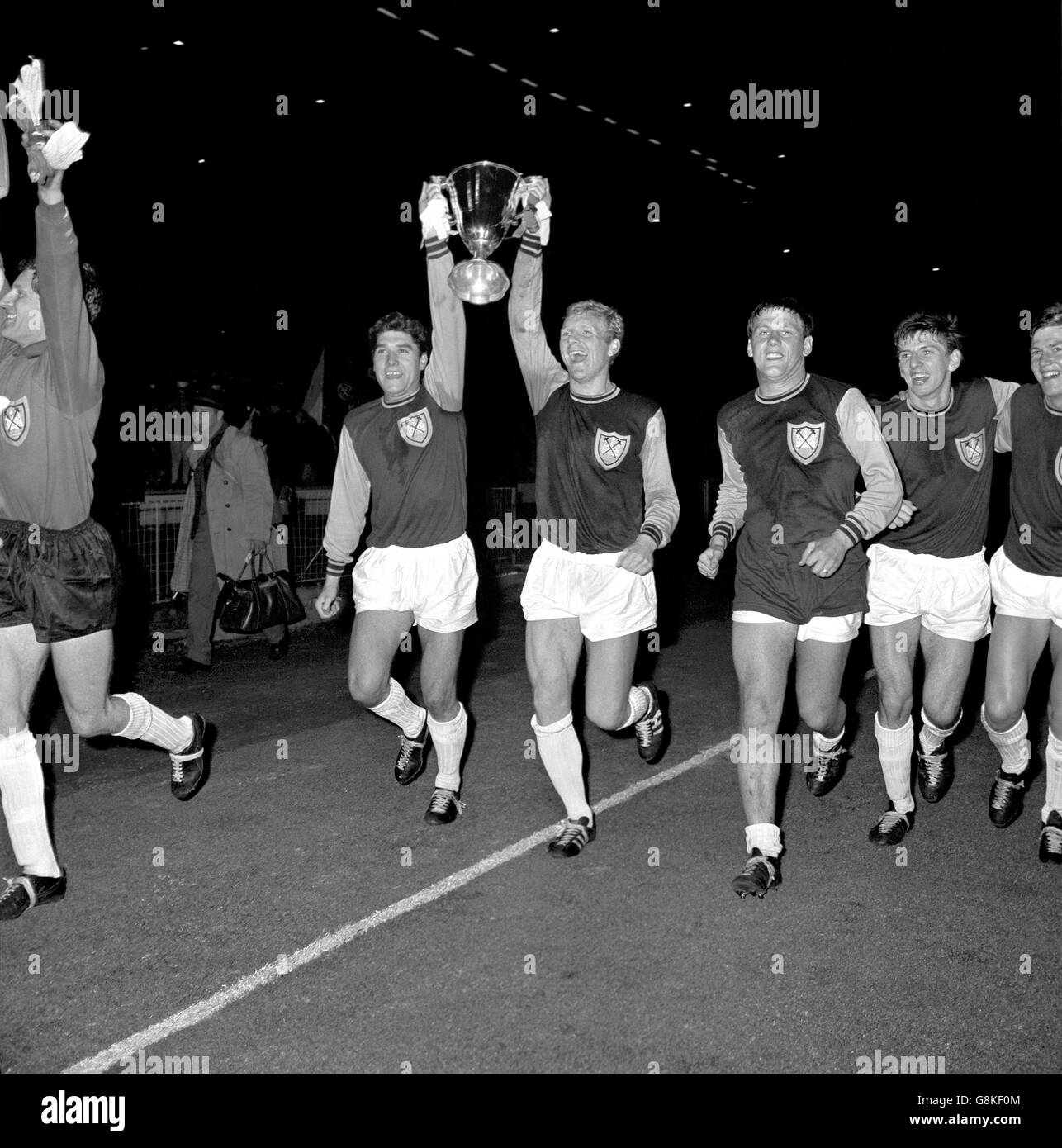 West Ham United A. Sealey, who scored both goals and West Ham captain Bobby Moore, hold high the trophy after beating TSV Munchen 2-0 in the final of the European Cup Winners Cup at Weembley. Stock Photo