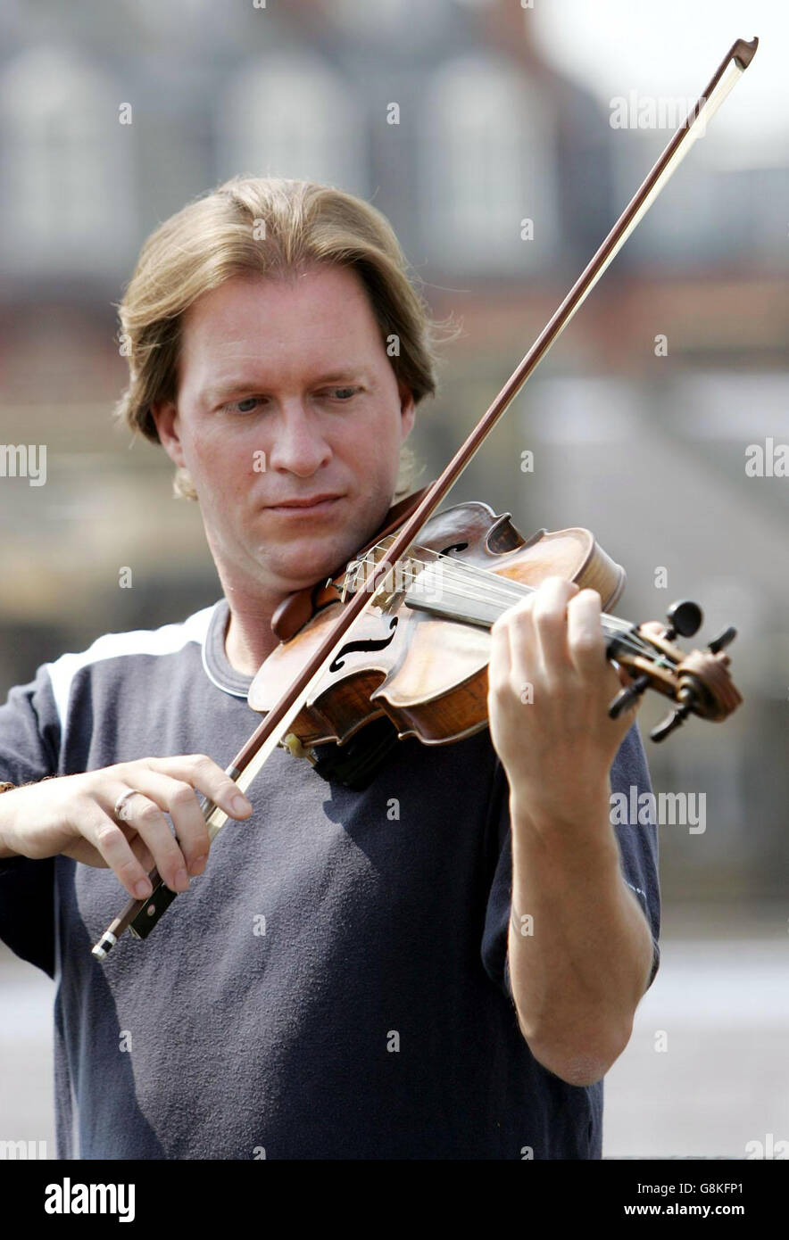 Alan Brind plays his rare Edward Lewis English violin dated to circa 1740 at Bonhams auction house in London. The instrument was recognised by a specialist at Bonhams as stolen when it was brought to the auction house by an unsuspecting trader and Alan Brind, the former Young Musician of the Year in 1986 was contacted and reunited with his violin. Stock Photo