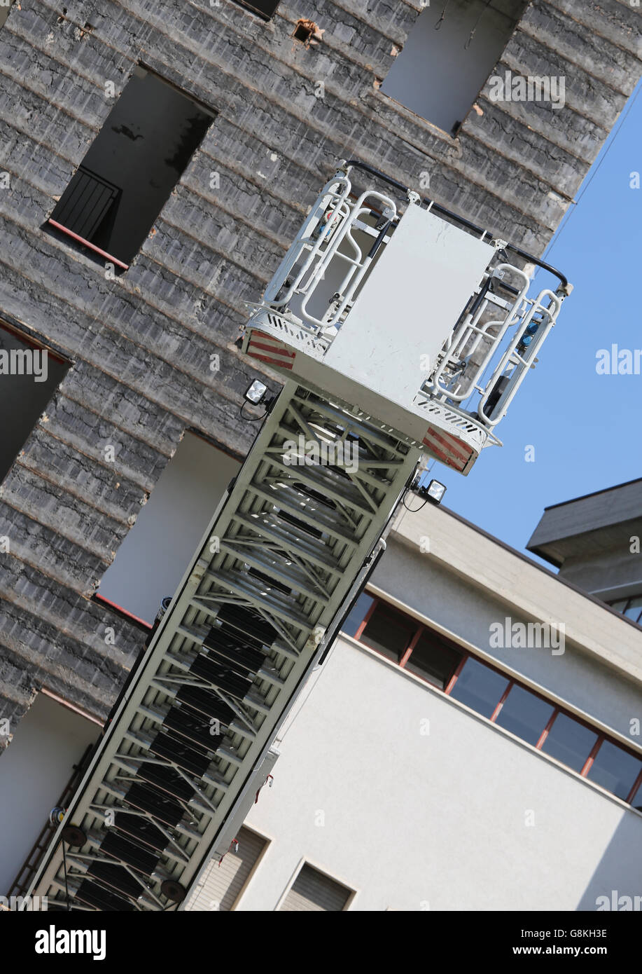 big elevator cage of fire truck with big ladder of firemen Stock Photo