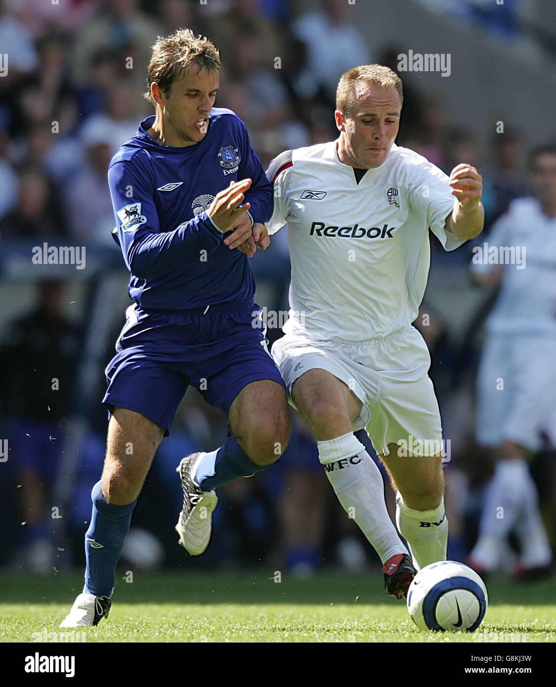Soccer - FA Barclays Premiership - Bolton Wanderers v Everton - Reebok Stadium. Everton's Phil Neville (l) challenges Bolton's Henrik Pedersen. Stock Photo