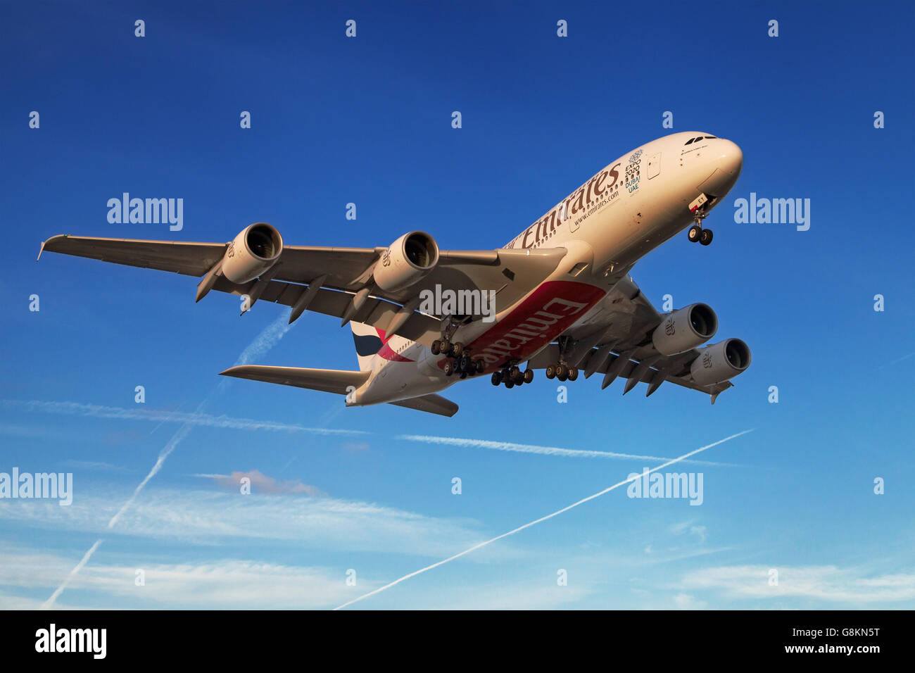 An Emirates Airbus A380-800 approaching at sunset to El Prat Airport in Barcelona, Spain. Stock Photo