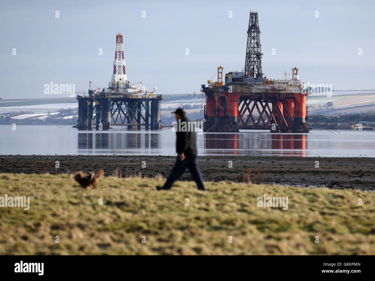 Oil platforms stand amongst other rigs laid-up in the Cromarty Firth ...
