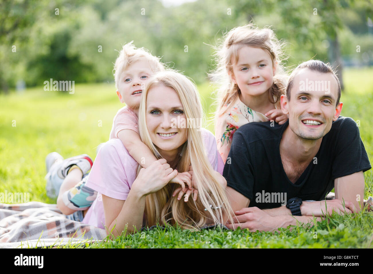 Family playing in the park Stock Photo - Alamy