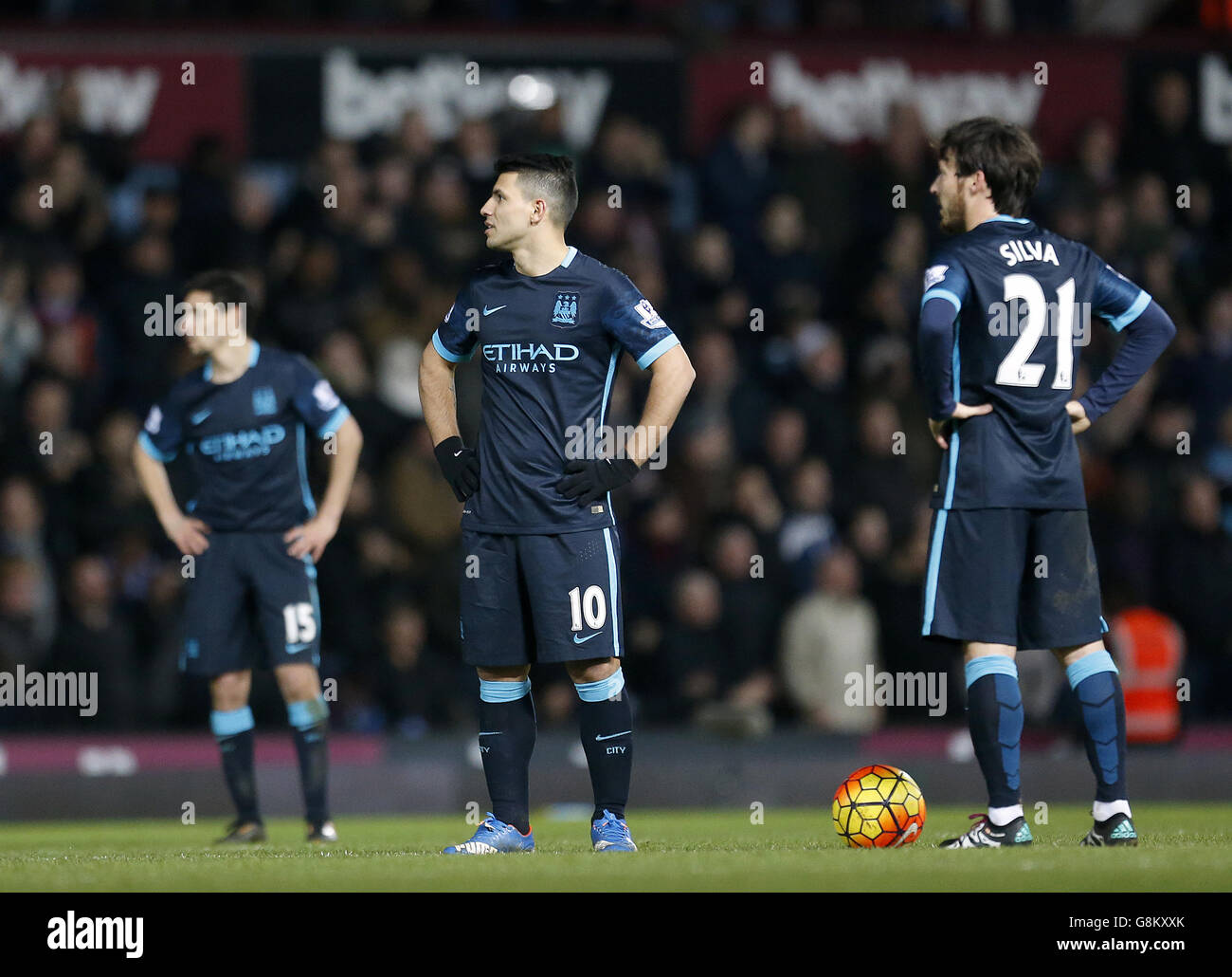 Manchester City's Sergio Aguero and David Silva react after West Ham United's Enner Valencia scores his side's second goal of the game during the Barclays Premier League match at Upton Park, London. Stock Photo