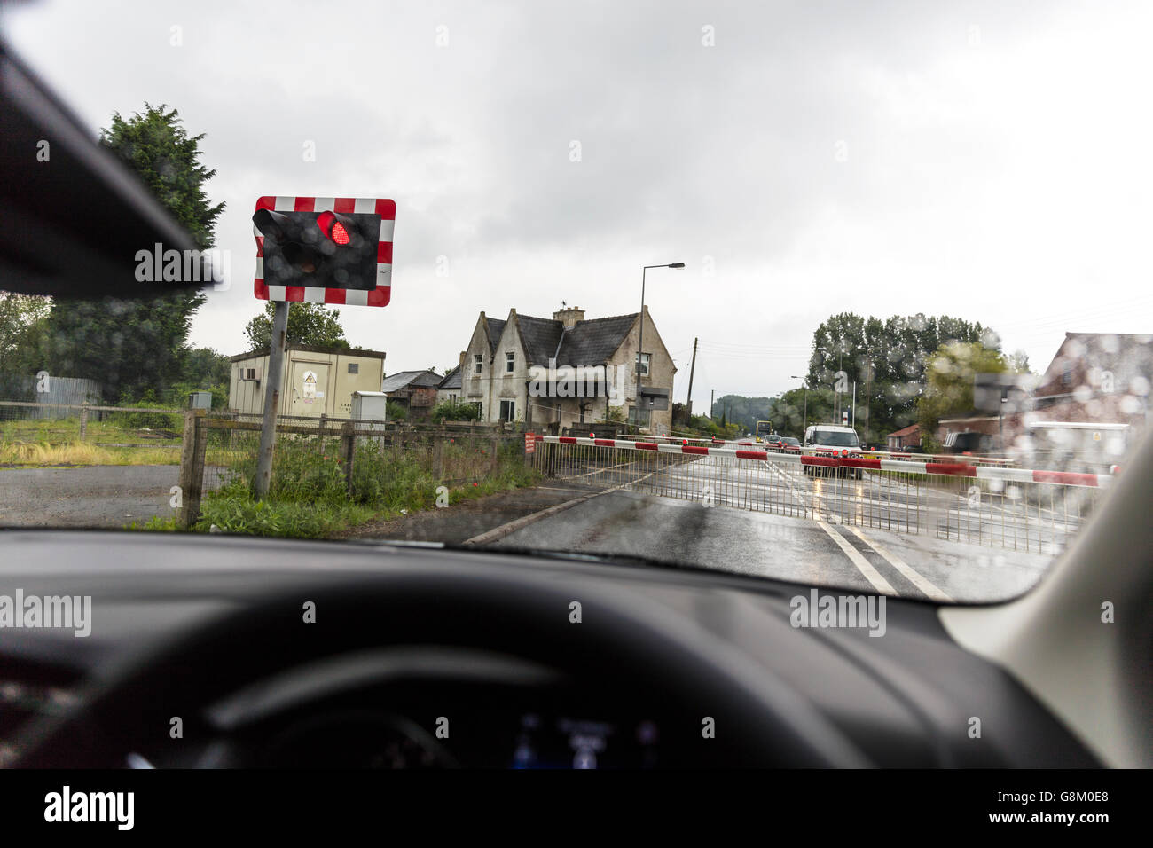 Waiting at level crossing barriers down lights flashing at Langworth