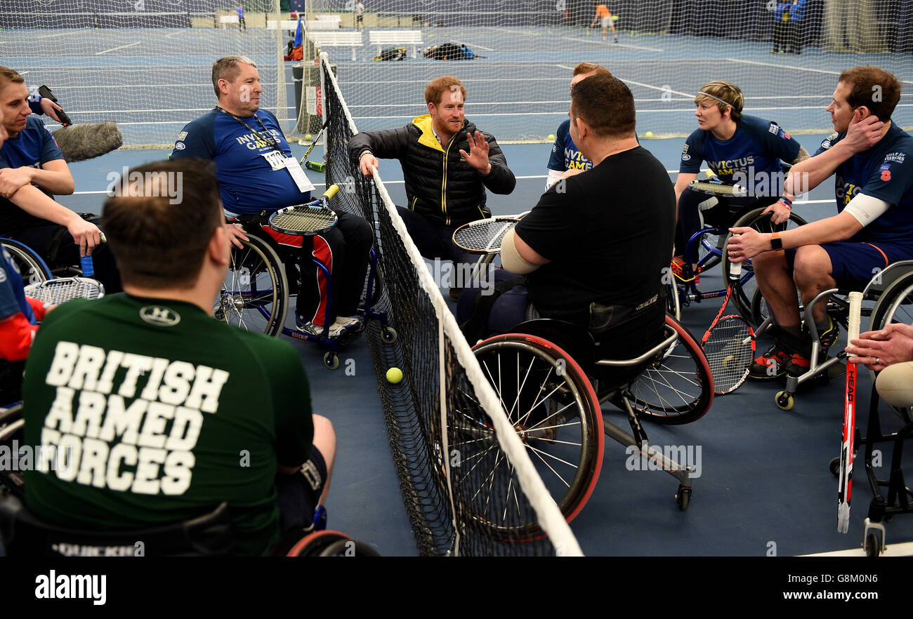 Prince Harry (centre) chats to competitors in the wheelchair tennis as